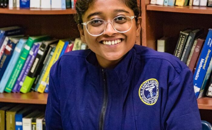 All Saints University student studying in the library