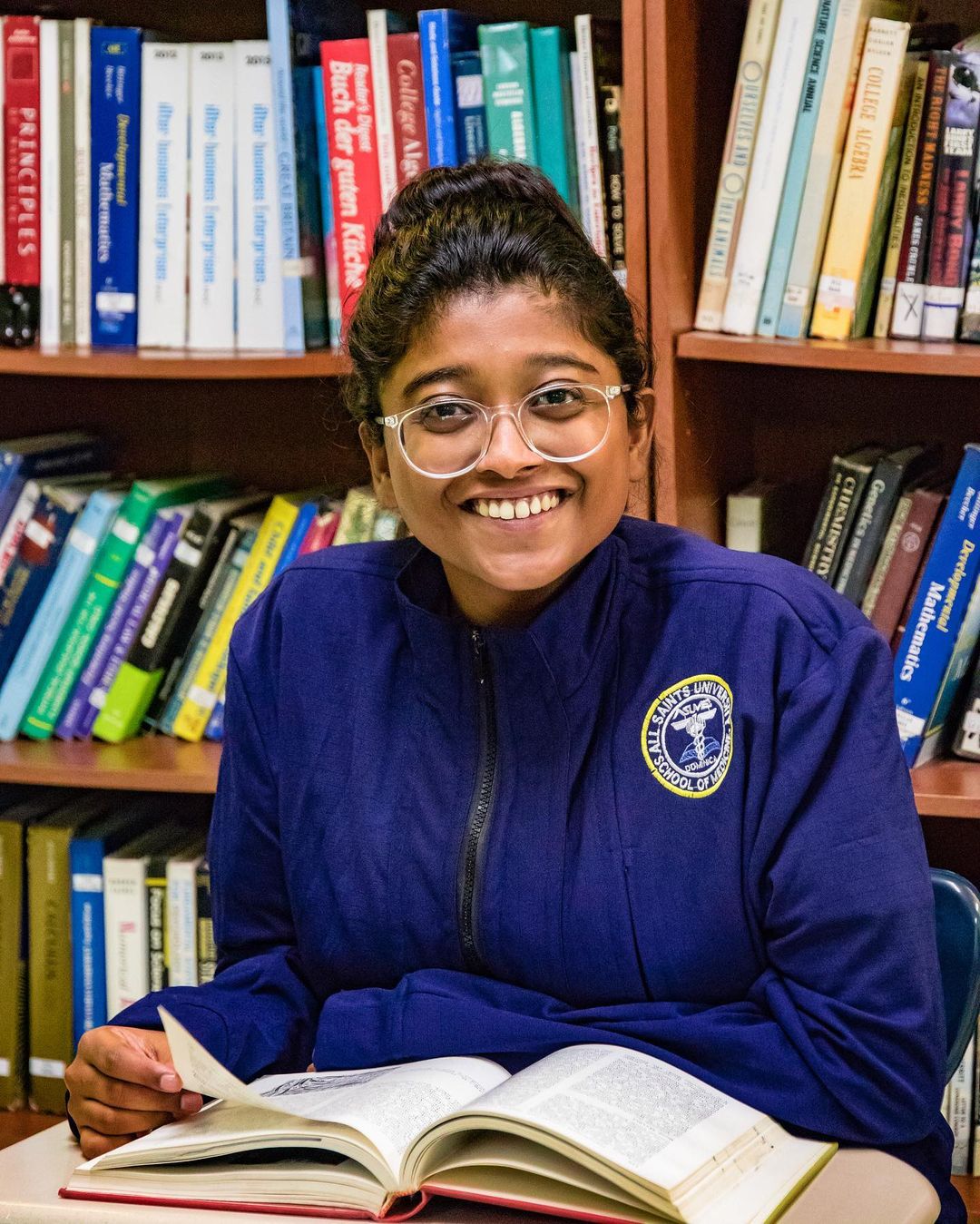 All Saints University student studying in the library